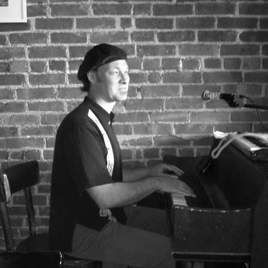 Ira Friedman playing piano in a professional setting