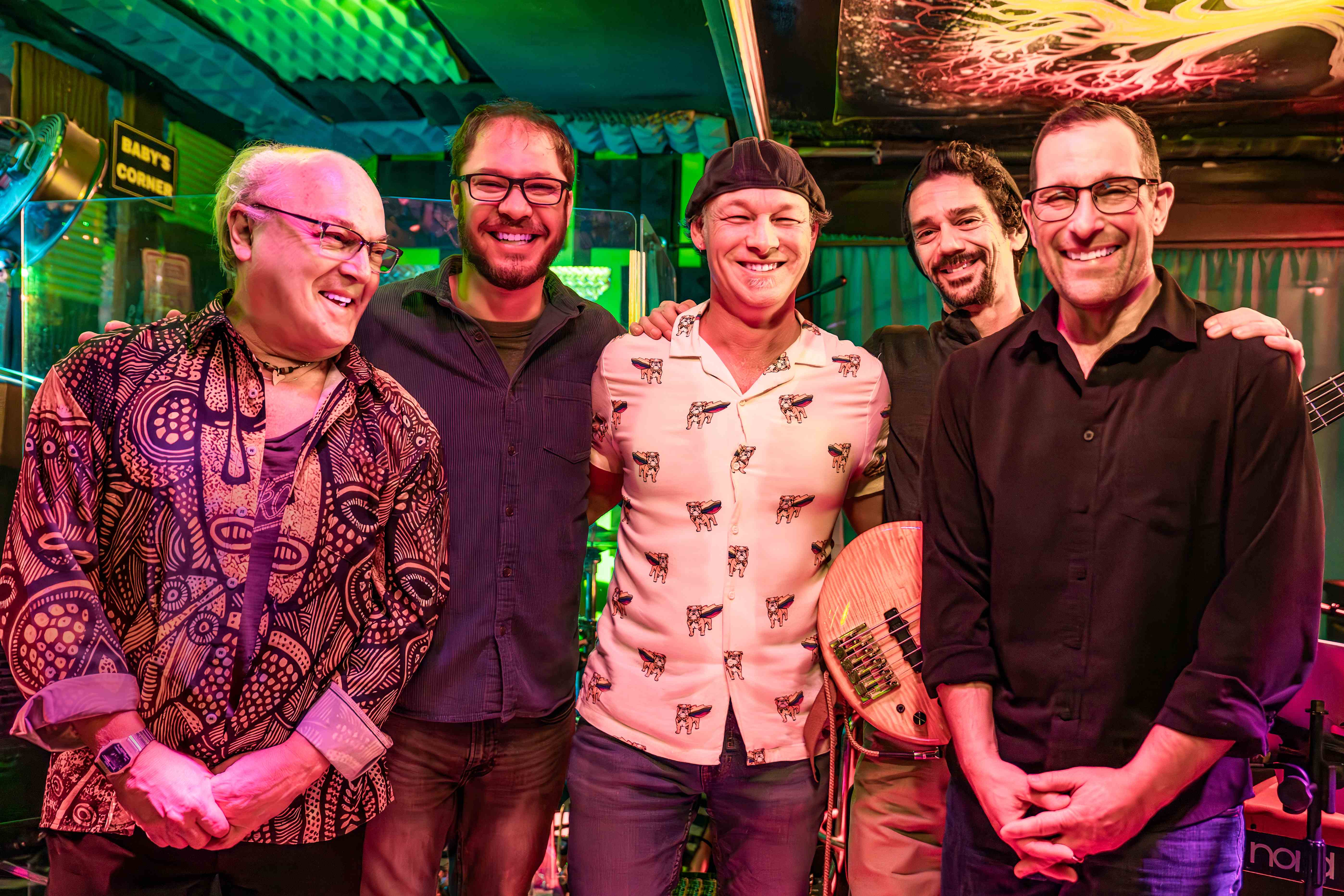 Soul Porpoise band members in a vibrant performance venue setting